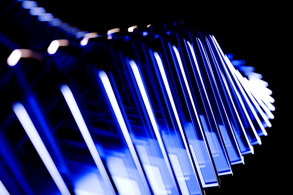 Close-up of a curved, abstract structure with blue and white illuminated rectangular elements against a black background.